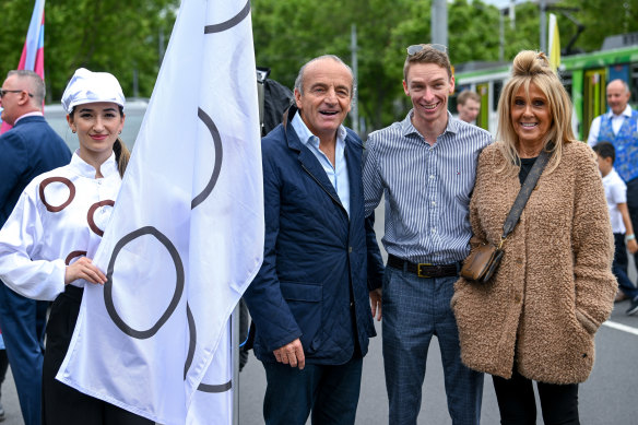 Melbourne Cup runner Lunar Flare owner John Valmorbida and wife Michelle show off its colours, formerly of Michelle’s parents’ horse Taj Rossi, with jockey Michael Dee. 