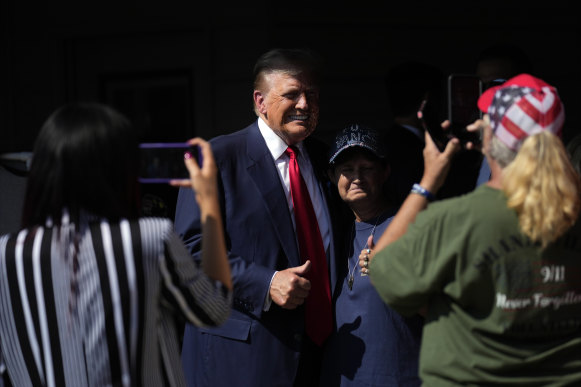 Loomer (left) takes a photo of Trump in Shanksville on Wednesday.