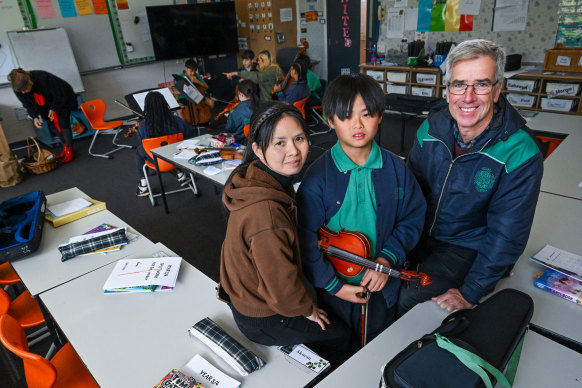 Sacred Heart School principal Matthew Shawcross (right) with student Kaien Vu and his mother, Linh Nguyen, says students are doing well overall.