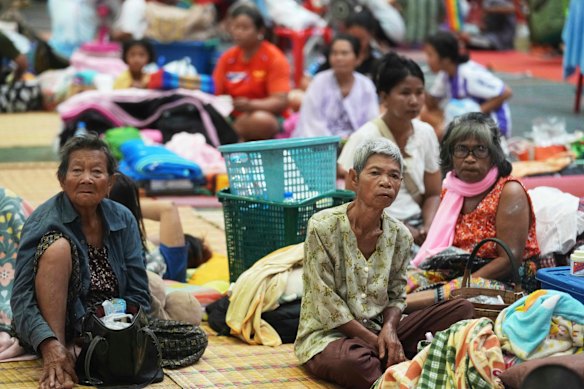 Thai residents who fled homes following clashes between Thai and Cambodian soldiers rest at an evacuation centre in Surin province, Thailand, on Friday.