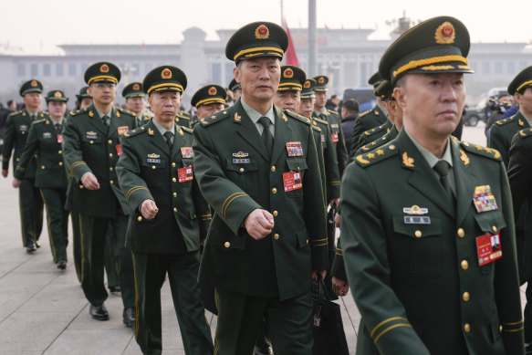 Military delegates march ahead of the opening session of the National People’s Congress. Beijing will boost defence spending by 7.2 per cent this year. 
