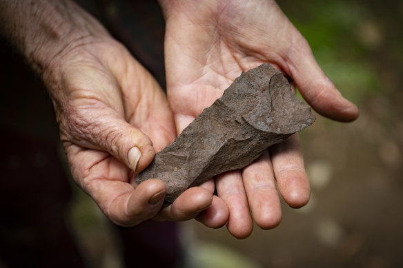 ‘Snowy’ Tavener holds a Polynesian adze at the archaeological dig site.