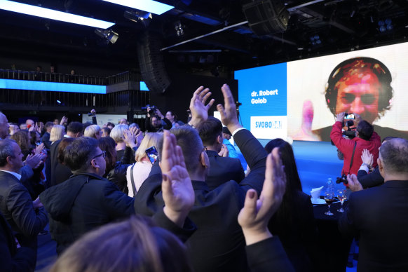 Opposition leader Robert Golob addresses his supporters from COVID isolation at an election night party. 