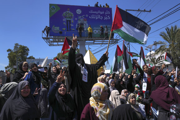 Women wave Palestinian flags and chant slogans during a rally in solidarity with Palestinian residents of the West Bank and Jerusalem, in Gaza City on Friday.