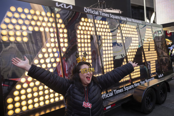 Actor Teresa Hui poses in front of the 2024 New Year’s Eve numerals are displayed in Times Square.