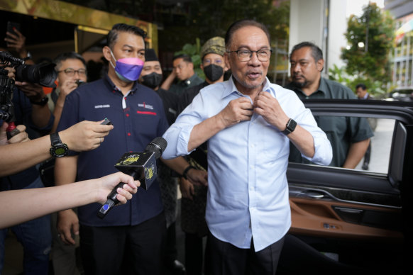 Malaysian opposition leader Anwar Ibrahim arrives at a hotel for talks on forming a governing coalition.