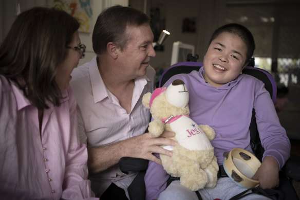Jessie Mei Mei, 20, with her host parents Cindy Lorenz and Gared O’Neill. Jessie was diagnosed at the age of 4 with Sanfillipo Syndrome, the root cause of her childhood dementia.