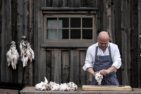 Chef Alberto Lozano hard at work outside Huset, his fine-dining restaurant in Svalbard.
