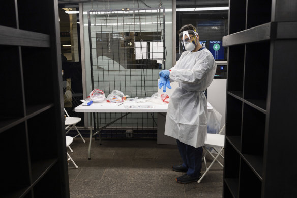 A medical worker waits at a COVID-19 testing site in the Times Square subway station in New York.