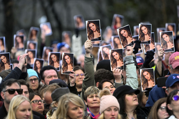 Visitors hold up photos as a service for Lisa Marie Presley comes to an end.
