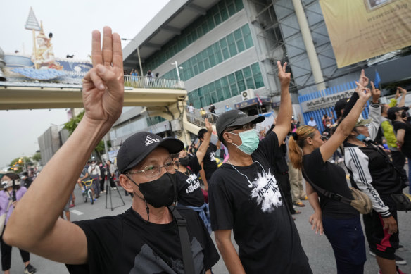 Anti-Prayuth protesters display the three-finger symbol of resistance during a demonstration in Bangkok in August.