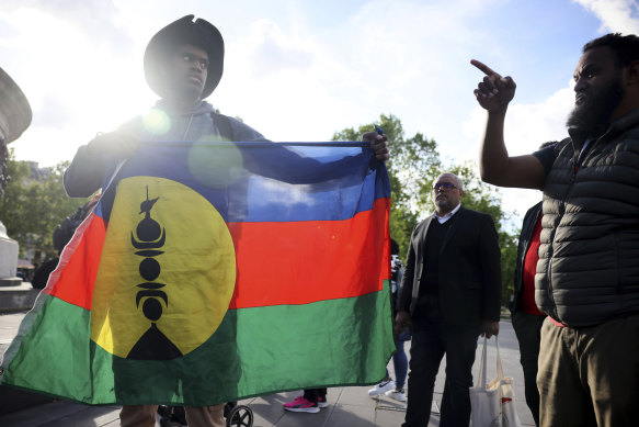 Demonstrators hold Kanak and Socialist National Liberation Front (FLNKS) flags during a gathering in Paris.