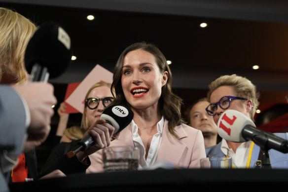 Sanna Marin peaks to media reacts as she watches results of exit polls in Helsinki.