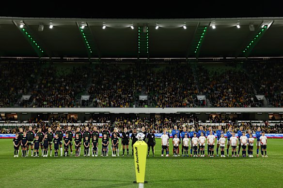 Australia and Slovenia players line up for the national anthems.