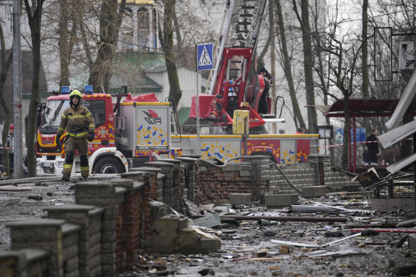 A firefighter walks amongst the debris after a Russian attack in Kyiv, Ukraine, on Thursday.