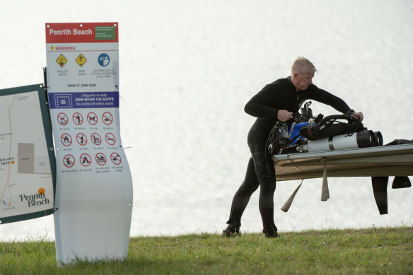 Police divers pack up after they located a body after a drowning at Penrith Beach.