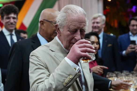 Charles sniffs a glass of a special Guyanese rum created in his honour in Georgetown.