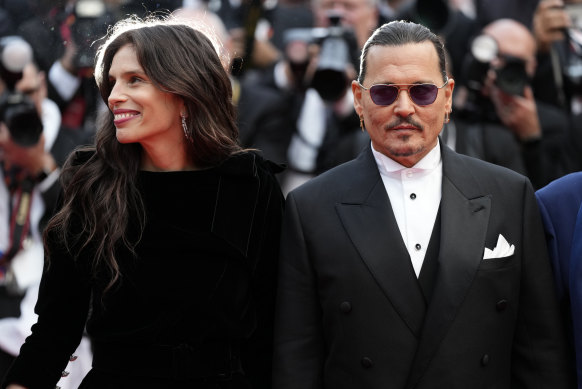 Johnny Depp arrives on the red carpet at Cannes for the opening night premiere of Jean du Barry, alongside director Maiwenn.