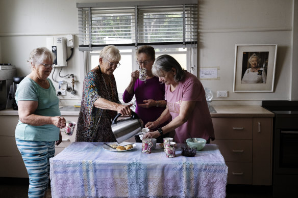 CWA members Lorna Dreghorn, Irene Stimson, Fay Harvey and Christine Pedemont on a tea break in the kitchen at the Stanwell Park CWA Hall where a portrait of Queen Elizabeth II hangs.