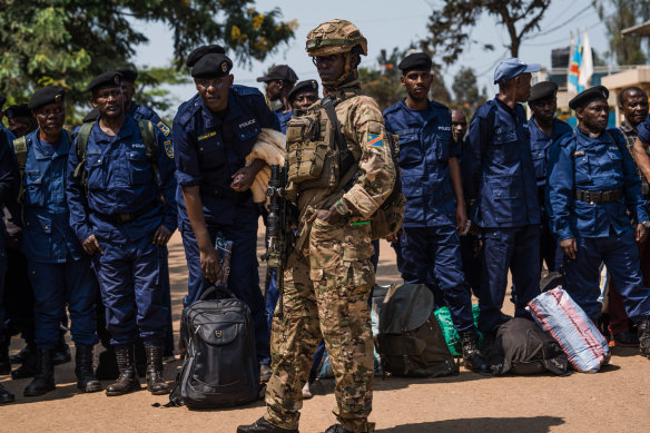 M23 rebels guard a unit of surrendering Congolese police officers who will be recruited into the rebel group, in Bukavu, Democratic Republic of Congo, at the weekend.
