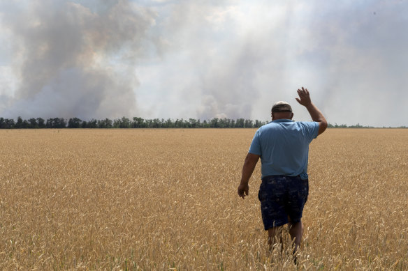 A farmer looks at his burning field caused by the fighting at the front line in the Dnipropetrovsk region, Ukraine.