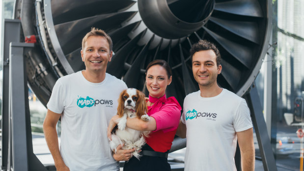 Mad Paws founders Jan Pacas and Alexis Soulopoulos with a Qantas staff member.