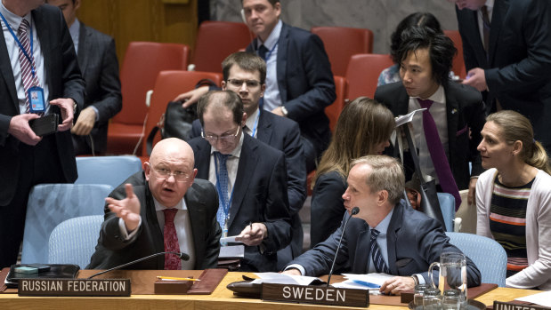 Russian Ambassador to the United Nations Vassily Nebenzia, left, speaks with Sweden\'s UN Ambassador Olof Skoog in the United Nations Security Council on Saturday.