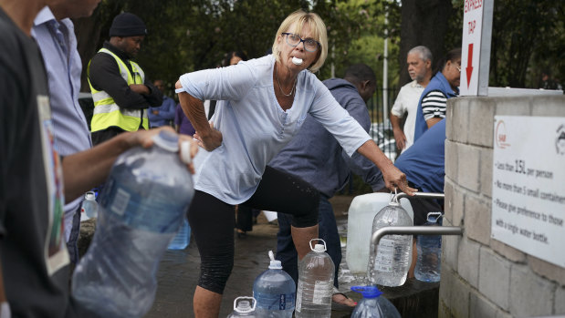 Residents collect water from a spring in the Newlands area of Cape Town.