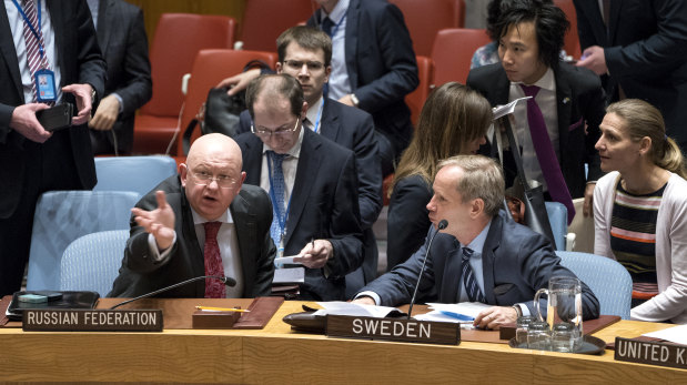 Russian Ambassador to the United Nations Vassily Nebenzia, left, speaks with Sweden's UN Ambassador Olof Skoog in the United Nations Security Council on Saturday.