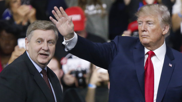President Donald Trump acknowledges the crowd during a campaign rally with Republican Rick Saccone.