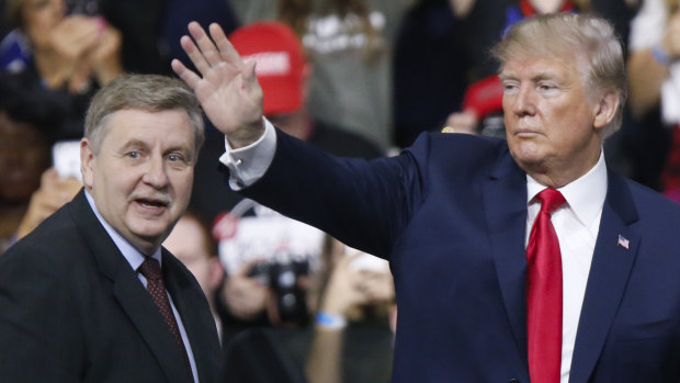 President Donald Trump, acknowledges the crowd during a campaign rally with Republican Rick Saccone.