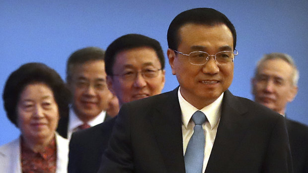 Chinese Premier Li Keqiang and vice premiers, from left, Sun Chunlan, Hu Chunhua, Han Zheng, and Liu He leave after a press conference.