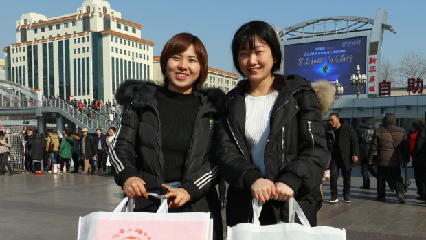 Wang Xuejiao (left), who works for a semi-conductor company, on her way home for new year.
