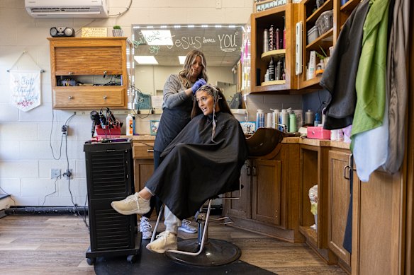 Amber Wheeler colours client Whitney Barnes’ hair in her salon, Steel Magnolia, in the Kentucky town of Magnolia.