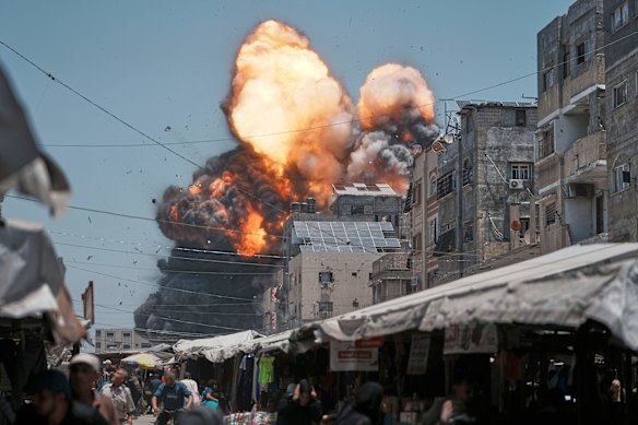 Thick smoke and flames erupt from an Israeli airstrike in Gaza City.