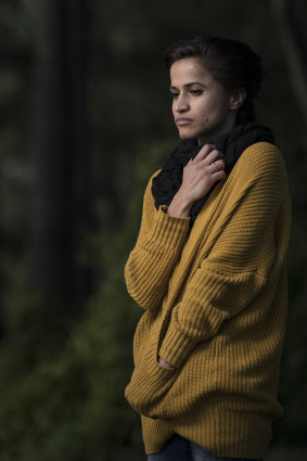 Nithya wears her sister Preethi's cardigan, looking out over the Nepean River.