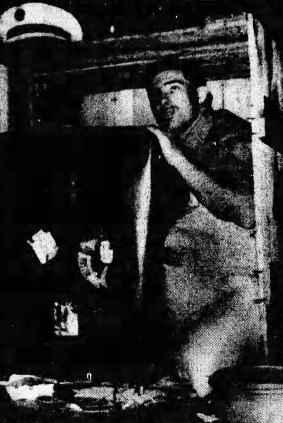 Pan American cargo handler Gary Hatch, who found stowaway Brian Robson, shows just how squeezed he must have been.