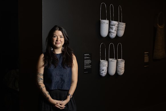 Telstra Work on Paper Award winner Jenna Mayilema Lee with her artwork <i>Taking Back Taken</i>.