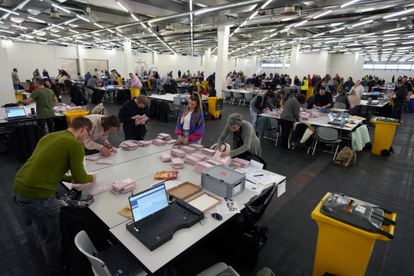 Volunteers in Munich sort postal votes during Sunday’s national election.