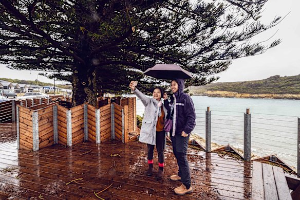 People taking selfies at Port Campbell. 