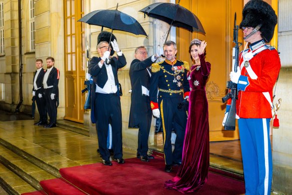 Crown Prince Frederik and Crown Princess Mary brave the rain.