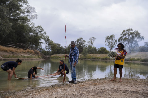 Barkandji artist Badger Bates launching the Barkandji Canoe which was created through the Art Gallery of New South Wales Djamu Indigenous Art Education Program. Wilcannia,