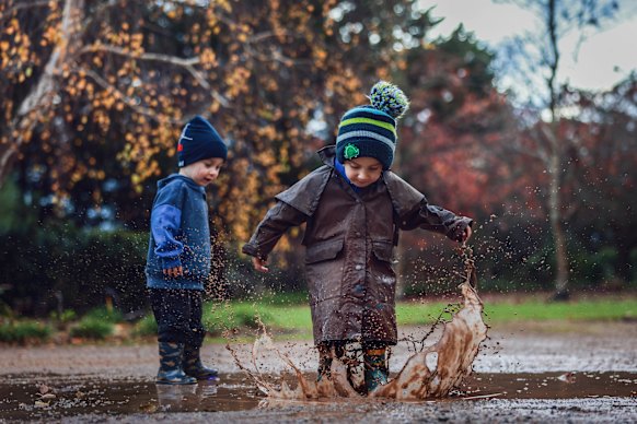 Odin Cockerill and Arlie Anson enjoy the wet weather at Gorae West, near Portland, in the state’s south-west. 