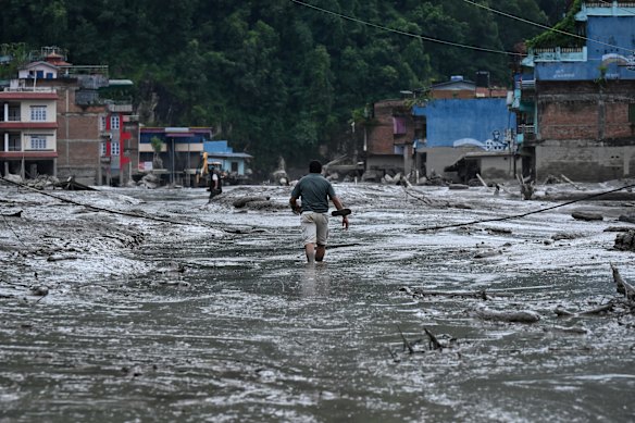 A resident after the flash floods hit Devighat in Nepal.