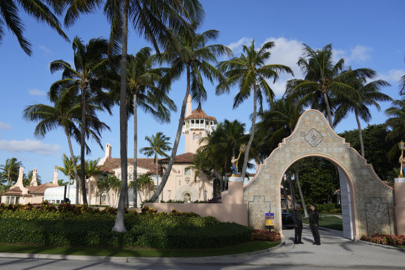 Security agents talk at the entrance to     Mar-a-Lago.