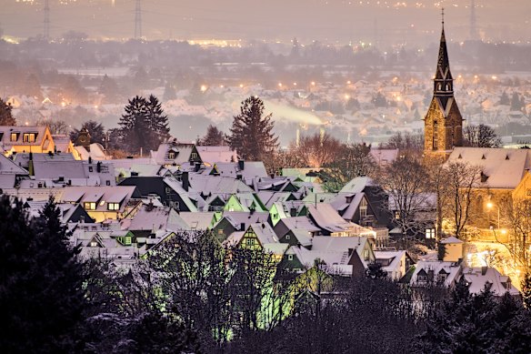 Freshly fallen snow lies on the roofs of houses in Kronberg near Frankfurt, on Tuesday.