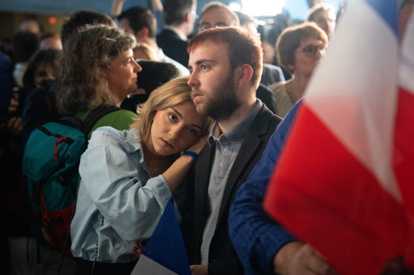 National Rally supporters react following the party’s defeat in the French parliamentary elections.