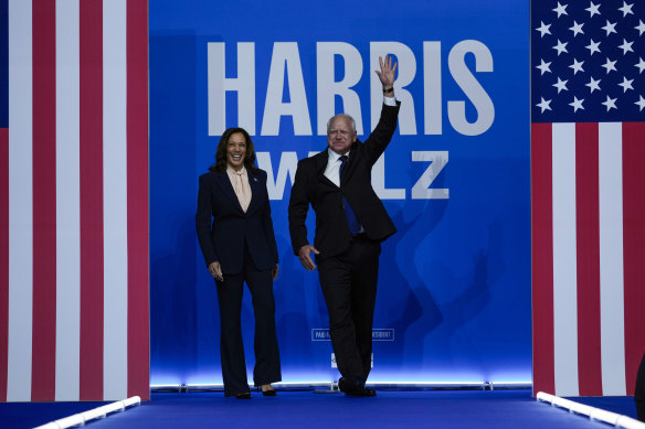 Democratic presidential nominee Kamala Harris and her running mate, Minnesota Governor Tim Walz, arrive at a campaign rally in Philadelphia.