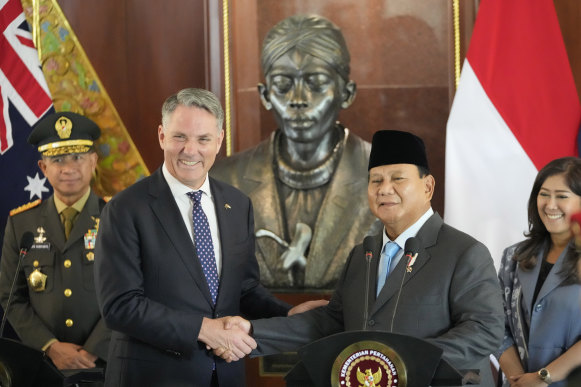 Indonesia’s Prabowo Subianto, right, shakes hands with Australia’s Richard Marles following their meeting in Jakarta on Friday.