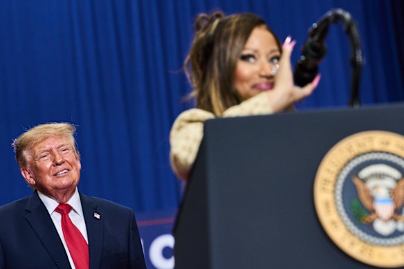 Nicki Minaj speaks at a Republican rally as Donald Trump listens last Sunday in Michigan.